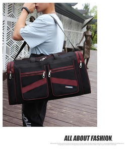 Detail of a black and wine red travel bag featuring multiple zipper pockets and sport logo