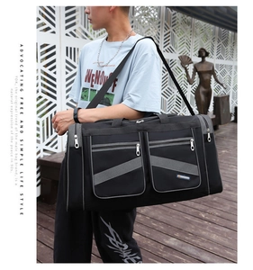 Detail view of large travel bag with waterproof nylon fabric and multiple zip pockets