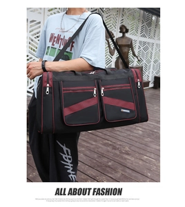 Black and red travel bag with adjustable strap worn by a male model in casual style