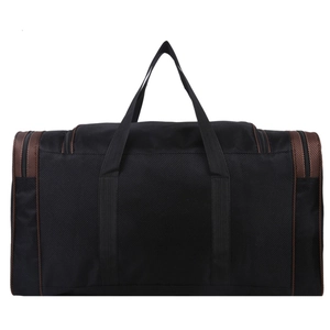 Close-up of black foldable travel bag featuring reinforced handles and bronze textured trim