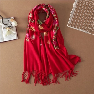 Elegant red wool shawl with traditional hand embroidery and fringe details for winter