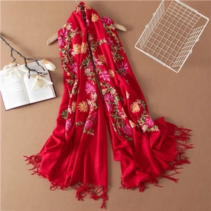 Elegant red wool shawl with hand-embroidered floral patterns and tassel fringe details