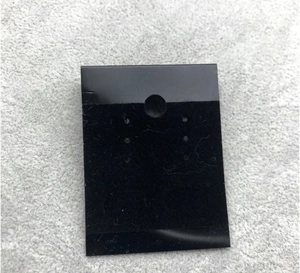 Detail of black PVC jewelry card with white Fashion Jewelry text and hanging hook