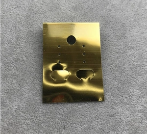 Macro shot of golden brushed PVC jewelry display card for earrings with Fashion Jewelry text
