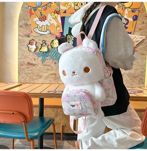 Detail of plush white rabbit backpack with pink patterned straps and soft faux fur texture