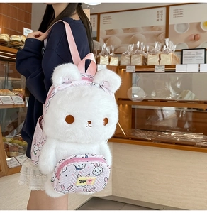 Detail of cute white plush rabbit backpack with pink straps and soft fur texture