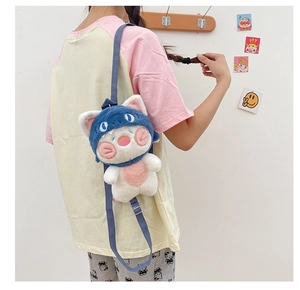 Close-up of a plush cat backpack with blue hood and adjustable straps on a model