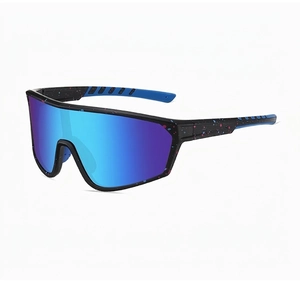 Detail of sports sunglasses featuring blue and pink spray paint patterns on black frame