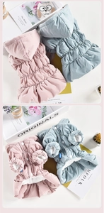 Detail view of floral pet coat with quilted texture and warm fleece lining