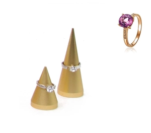 Detailed macro view of purple gemstone ring on golden cone jewelry display stand