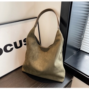 Detailed close-up of olive green suede hobo bag showing soft texture and vintage style