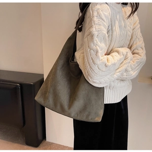 Detail of the soft olive green suede tote bag showing rich texture and large capacity