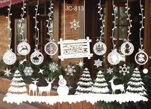 Close-up of white Merry Christmas window stickers with snowflake and reindeer patterns