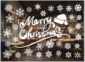 Close-up of white snowflake static window stickers and Merry Christmas artistic decals