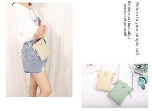 Detail of embroidered floral crossbody phone bags in beige and mint green PU leather