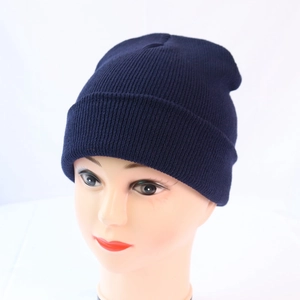 Close-up of navy blue ribbed knit beanie with fold-over cuff on a display head