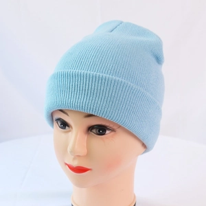 Close-up of the light blue knit beanie showing fine ribbing and classic fold-over cuff