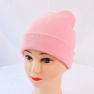 Close-up of pink ribbed knit beanie hat texture on mannequin for winter warmth
