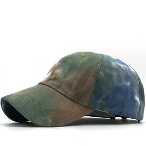Detail of multi-color tie-dye cotton baseball cap with embroidered eyelets and camo effect