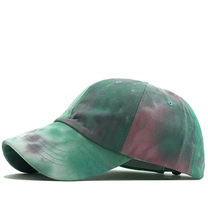 Side view of cotton tie-dye ponytail baseball cap with green and purple color transition