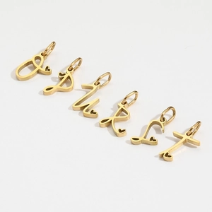 Detailed view of six golden stainless steel alphabet charms featuring tiny heart details