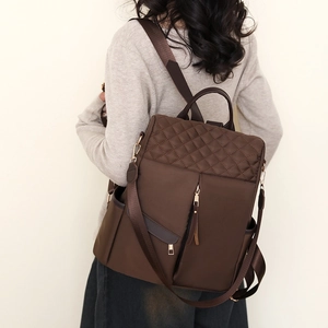 Deep brown nylon backpack for women featuring stylish diamond quilted stitching and metal zippers