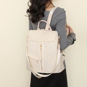 Chic quilted cream nylon backpack with diamond stitching and adjustable straps