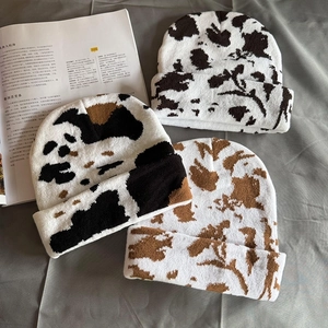 Vintage cow print knitted beanies in black, brown and white for couple's winter fashion