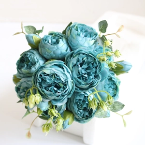 Macro detail of artificial teal peony bouquet with realistic silk petals and flower buds