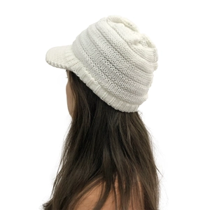Detailed side view of white chunky knit visor beanie showing textured yarn and warm ear flaps