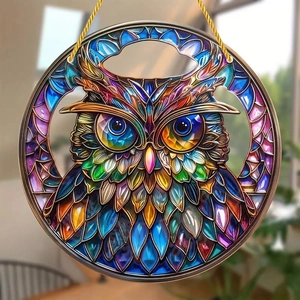 Detail of colorful stained glass owl suncatcher with intricate textures and gold hanging cord