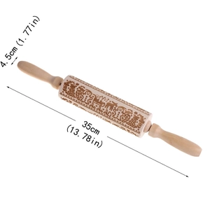 Close-up of engraved Christmas rolling pin with reindeer and snowflake patterns