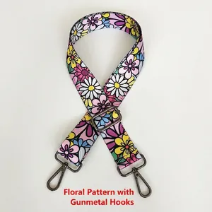 Detail of colorful daisy patterned bag strap with gunmetal swivel snap hooks
