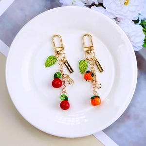 Cute fruit keychain set with cherry and persimmon pendants for bags and Airpods