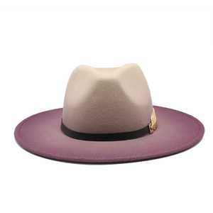 Detail of gradient fedora hat featuring purple ombre wool felt and gold chain accessory