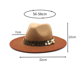 Detail view of khaki and red fedora with leopard band and pearl floral accents