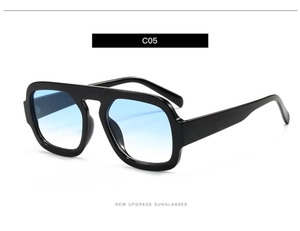 Detail of black thick frame sunglasses with light blue gradient lenses and high gloss finish
