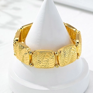 Vintage gold geometric bracelet featuring embossed leaf patterns and pearl textures