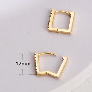 Detail view of 12mm gold square hoop earrings with fine zircon side inlay