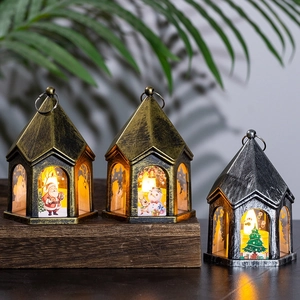 Three vintage Christmas LED lanterns with Santa and Snowman on a wooden surface