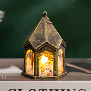 Detail of vintage Christmas LED lantern featuring painted snowman and reindeer design