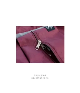 Close-up of double-sided zipper design on burgundy foldable travel bag with WALK lining