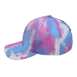 Tie-dye cross ponytail baseball cap with pink and blue gradient print on white background