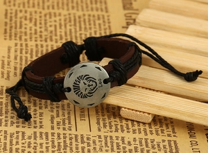 Macro shot of vintage Leo zodiac leather bracelet with engraved lion metal charm detail