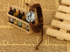 Detail view of woven brown leather Capricorn zodiac bracelet with silver pendant