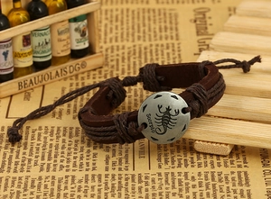 Macro shot of Scorpio vintage leather bracelet with antique silver zodiac charm
