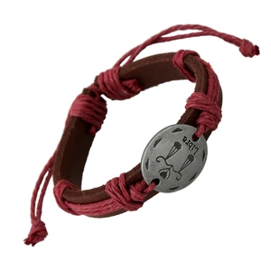Adjustable woven leather Libra zodiac bracelet with brown and red cords on white background