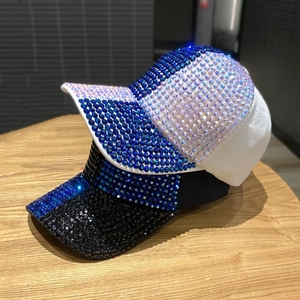 Sparkling rhinestone-studded baseball caps in black and white with blue crystals
