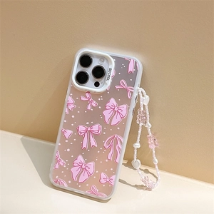 Detail of clear iPhone case with pink bows, polka dots, and a beaded teddy bear strap