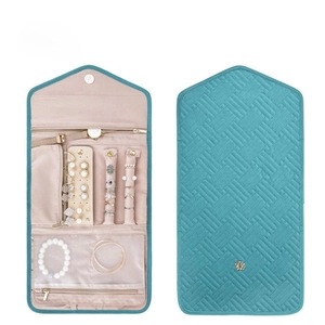 Internal compartments of the foldable quilted jewelry travel organizer in teal and beige